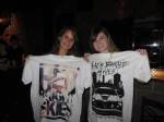 Chelle met a new friend at the concert. They are showing off their new shirts.