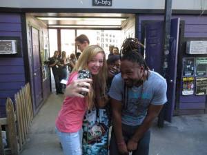 Manny, the drummer for Ghost Town, takes a selfie with his fans.