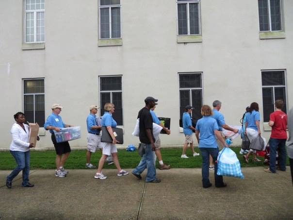 On Matriculation Day the "Blue Shirt" volunteers are parents of cadets who volunteer to help the new cadets get settled in. Here you can see a group carrying items into 1st Battalion. 
