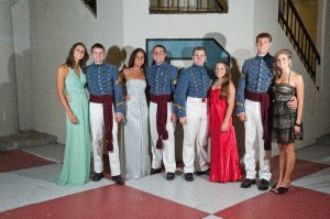 A few members of Bravo Company and their dates pose by the company letter before they walk through the ring.