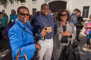 Celebrating with cadet Lucas are his mother's friend Pat (in blue) and Dorothy Lucas. photo by Stanley Leary